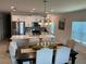 Well-lit dining area adjacent to the modern kitchen with stainless steel appliances at 6841 Wilson Hammock Ave, Groveland, FL 34736