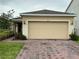 Charming single-story home featuring a brick driveway and a spacious two-car garage at 6841 Wilson Hammock Ave, Groveland, FL 34736