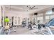 Well-equipped fitness center with treadmills, weight machines, and ample natural light from large windows at 6841 Wilson Hammock Ave, Groveland, FL 34736