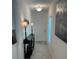 Bright hallway leading to the front door, decorated with a console table at 6841 Wilson Hammock Ave, Groveland, FL 34736