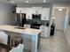 Bright, updated kitchen featuring stainless steel appliances, quartz countertops and a center island at 6841 Wilson Hammock Ave, Groveland, FL 34736