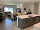 Open-concept kitchen and dining area with a view into the cozy living room at 6841 Wilson Hammock Ave, Groveland, FL 34736