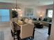 Cozy living room area with tile floors and natural light, next to the dining area at 6841 Wilson Hammock Ave, Groveland, FL 34736
