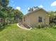 Lush backyard with a well-maintained lawn, mature trees, and landscaping at 700 E Mattie St, Sanford, FL 32773
