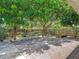 Spacious brick-paved backyard with mature trees and a serene outdoor seating area at 700 E Mattie St, Sanford, FL 32773