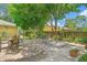 Paved backyard patio with mature trees and an outdoor dining area, offering a relaxing and inviting space at 700 E Mattie St, Sanford, FL 32773