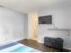 This bedroom includes a TV and an ensuite bathroom, offering both entertainment and convenience at 700 E Mattie St, Sanford, FL 32773