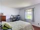 Comfortable bedroom with a work area with natural light streaming through a window, creating a pleasant atmosphere at 700 E Mattie St, Sanford, FL 32773
