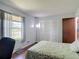 Bedroom features a window with views of the outdoors and ample storage space with closet at 700 E Mattie St, Sanford, FL 32773