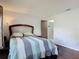 A cozy bedroom features hardwood floors and an adjoining bathroom for added privacy and convenience at 700 E Mattie St, Sanford, FL 32773