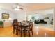 Dining room with hardwood floors features an elegant chandelier and flows into the living area at 700 E Mattie St, Sanford, FL 32773