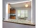 Stylish kitchen with granite countertops overlooking a sunlit dining area and cozy breakfast nook at 700 E Mattie St, Sanford, FL 32773