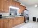 Spacious kitchen features stainless steel appliances, granite countertops, and ample cabinet space with view to dining area at 700 E Mattie St, Sanford, FL 32773