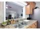 Stylish kitchen with granite countertops, stainless steel sink, and ample cabinet space overlooking dining area at 700 E Mattie St, Sanford, FL 32773