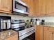 Modern kitchen featuring stainless steel appliances, granite countertops, and tiled backsplash at 700 E Mattie St, Sanford, FL 32773