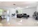 Spacious living room with tile floors, a modern sofa, and lots of natural light at 700 E Mattie St, Sanford, FL 32773