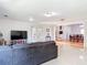 Open-concept living room showcasing tile floors and access to the dining area at 700 E Mattie St, Sanford, FL 32773