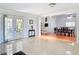 Spacious living room with tile floors features French doors and an open layout to the dining area at 700 E Mattie St, Sanford, FL 32773