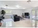 Bright living room boasts tile floors, contemporary furniture, and lots of natural light at 700 E Mattie St, Sanford, FL 32773