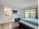 Cozy main bedroom features a window view and an ensuite bathroom at 700 E Mattie St, Sanford, FL 32773