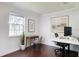 Bright office space with two desks, a large window and hardwood floors at 700 E Mattie St, Sanford, FL 32773