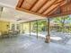 Spacious covered patio with a dining set, outdoor seating, and a well-maintained backyard at 700 E Mattie St, Sanford, FL 32773