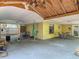 Spacious covered patio featuring an outdoor dining area, storage, and connection to the backyard at 700 E Mattie St, Sanford, FL 32773