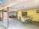 Covered patio features an outdoor dining area and access to the large backyard with a covered carport and ample space at 700 E Mattie St, Sanford, FL 32773
