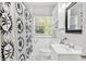 Clean bathroom featuring black-and-white patterned shower curtain and bright lighting at 725 S Hampton Ave, Orlando, FL 32803
