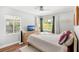 Bright bedroom with two windows, a dresser, and neutral tones at 725 S Hampton Ave, Orlando, FL 32803