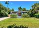 Inviting single-story home featuring lush landscaping, a vibrant lawn, and a brick-paved driveway at 725 S Hampton Ave, Orlando, FL 32803