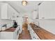 Bright kitchen with brick floors, white cabinets, butcher block countertops, and stainless steel appliances at 725 S Hampton Ave, Orlando, FL 32803
