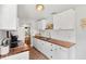 Bright kitchen with brick floors, white cabinets, wood countertops, and stainless steel appliances at 725 S Hampton Ave, Orlando, FL 32803