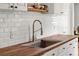 Close-up of a stainless steel sink with spring faucet and wood countertop in bright kitchen at 725 S Hampton Ave, Orlando, FL 32803