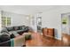 Inviting living room with a gray sectional, hardwood floors, and stylish decor, creating a warm ambiance at 725 S Hampton Ave, Orlando, FL 32803