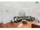 Bright living room featuring a comfortable sectional sofa, hardwood floors, and natural light at 725 S Hampton Ave, Orlando, FL 32803