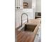 Close-up of a stainless steel sink with spring faucet and wood countertop in bright kitchen at 725 S Hampton Ave, Orlando, FL 32803