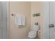 Simple bathroom with toilet, towel rack, and neutral decor, offering a clean and functional space at 730 Siena Palm Dr # 201, Celebration, FL 34747