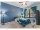 This blue bedroom features stylish decor, natural light, and a comfortable bed setting at 730 Siena Palm Dr # 201, Celebration, FL 34747