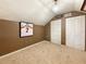 A cozy bedroom features unique architectural details, carpeted floor, and ample closet space at 730 Siena Palm Dr # 201, Celebration, FL 34747