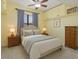 Cozy bedroom with neutral tones, featuring a comfortable bed, ceiling fan, and ample storage at 730 Siena Palm Dr # 201, Celebration, FL 34747