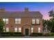 Charming two-story building featuring a decorative tile roof and arched windows at 730 Siena Palm Dr # 201, Celebration, FL 34747
