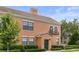 Charming two-story home with tile roof, green door, manicured landscaping, and stucco siding at 730 Siena Palm Dr # 201, Celebration, FL 34747