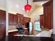 Charming kitchen featuring wood cabinets, a stainless steel refrigerator, and a unique, decorative red chandelier at 730 Siena Palm Dr # 201, Celebration, FL 34747