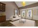 A living room featuring large windows with sheer curtains, a neutral sofa, and a modern coffee table at 730 Siena Palm Dr # 201, Celebration, FL 34747