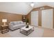 Bright, stylish living room with sleek furniture, carpet, and natural light, ideal for relaxation and entertaining at 730 Siena Palm Dr # 201, Celebration, FL 34747