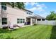 Large backyard featuring lush green lawn and covered patio seating area at 750 Maple Leaf Loop, Winter Springs, FL 32708
