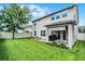 Expansive backyard featuring lush lawn, patio, and outdoor seating area at 750 Maple Leaf Loop, Winter Springs, FL 32708