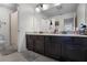 Bathroom featuring a double vanity with dark cabinets and tile flooring at 750 Maple Leaf Loop, Winter Springs, FL 32708
