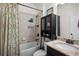 This bathroom features a granite countertop and a shower/tub combo with tiled walls and a shower curtain at 750 Maple Leaf Loop, Winter Springs, FL 32708